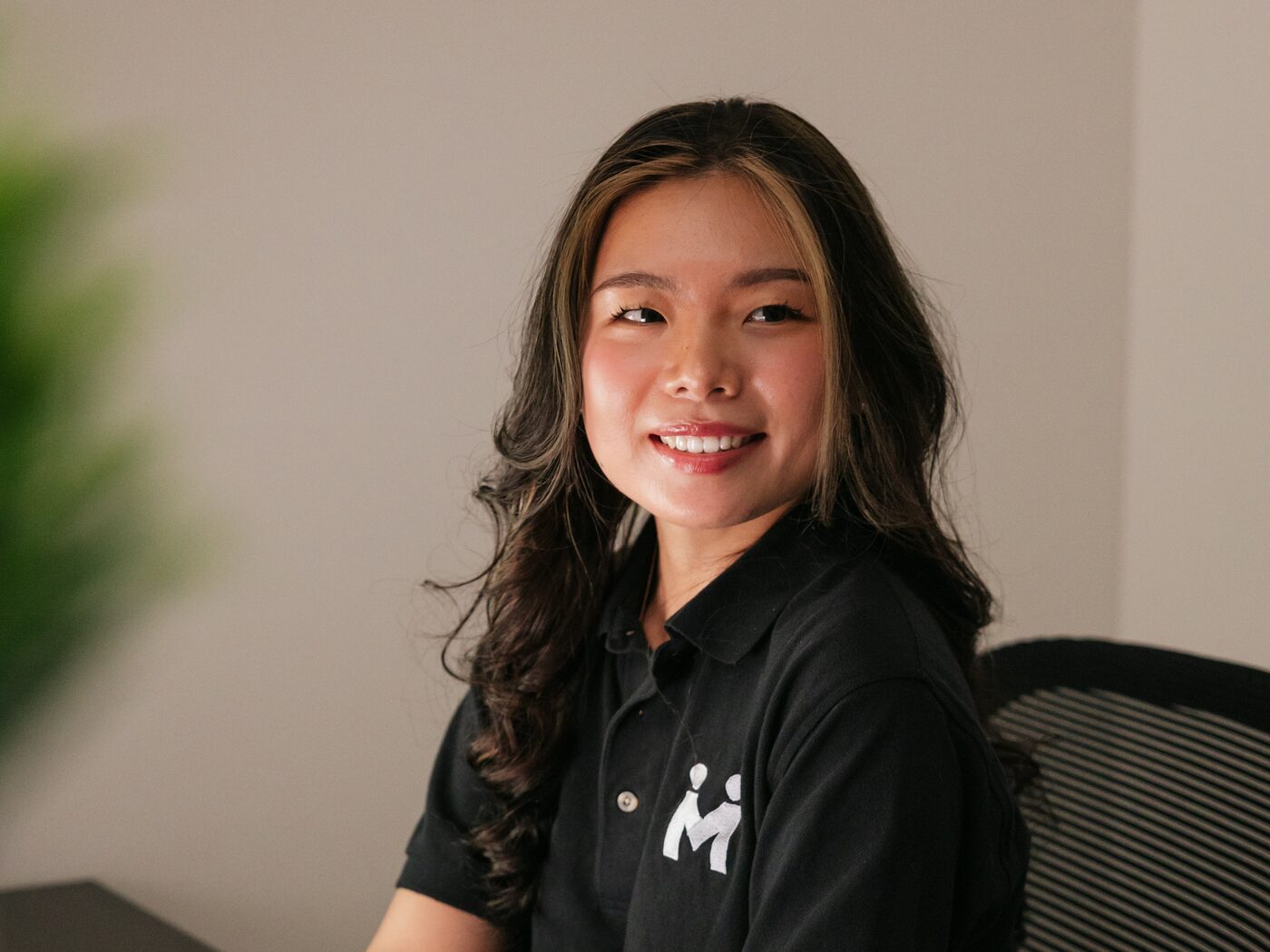 Vivian Liu smiling at her desk in the Integrity Marketing studio