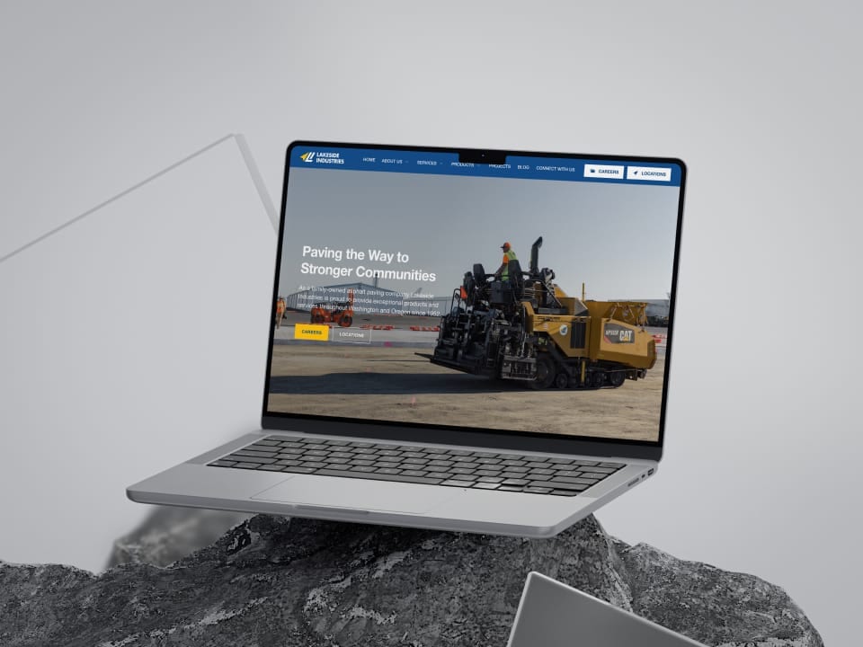 Laptop displaying Lakeside Industries website on rocky surface